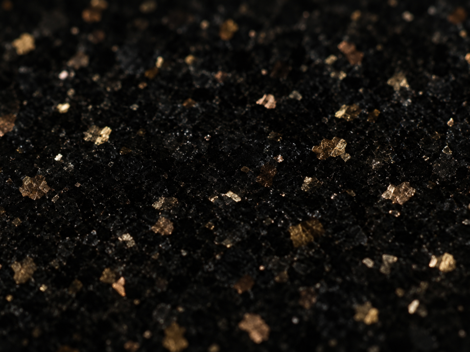 Black Galaxy granite polished surface showing golden-bronze mineral speckles — exclusively quarried in Ongole, Andhra Pradesh, India, Nirvan Exports