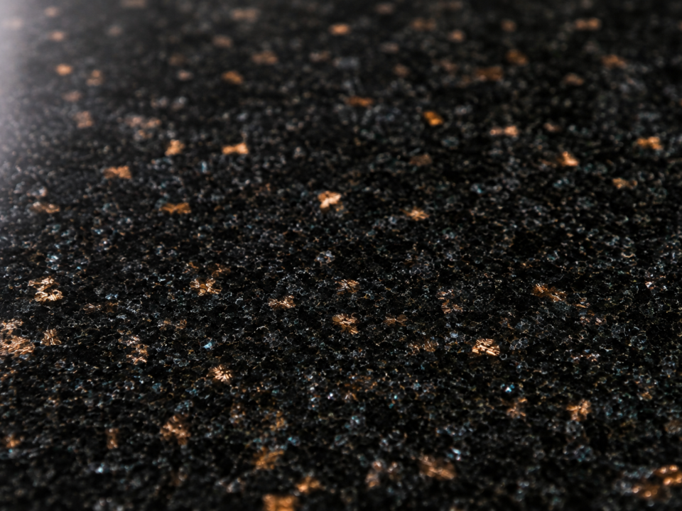 Polished Black Galaxy granite surface showing golden bronze flecking